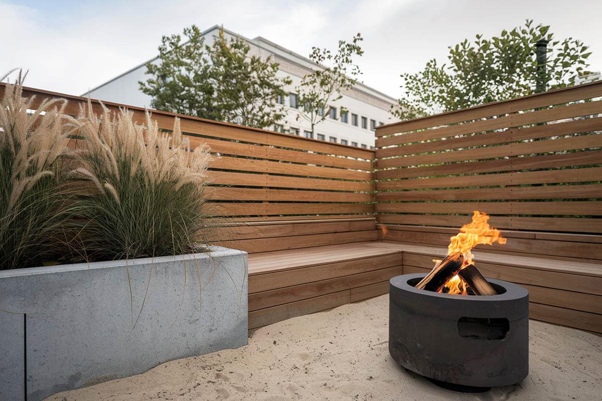 Concrete planter next to fence made of wood