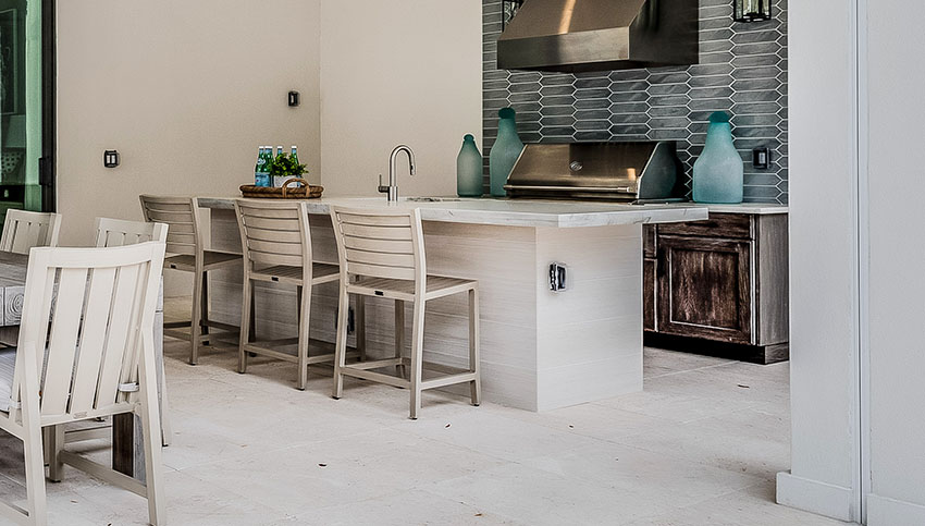 Galley kitchen with counter stools and ceiling height backsplash
