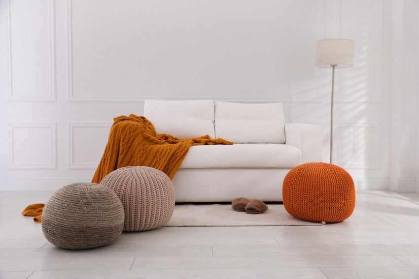 Room with poufs, couch, and floor lamp