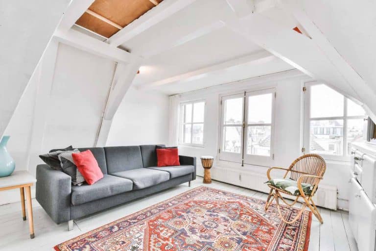 attic room with sofa and windows